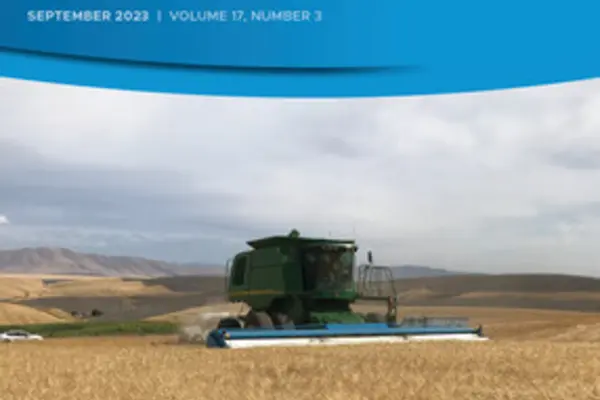 Cover of Journal of Plant Registrations. A combine harvesting a field of Successor barley in Oregon. 